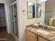 Bathroom featuring a glass shower and granite countertops at 15225 N 100Th St # 1220, Scottsdale, AZ 85260