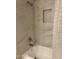 Bathroom bathtub and shower featuring tiled walls and a shower niche at 15225 N 100Th St # 1220, Scottsdale, AZ 85260