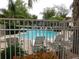 Relaxing community pool with lounge chairs, umbrellas, and lush landscaping at 15225 N 100Th St # 1220, Scottsdale, AZ 85260