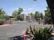 Gated entrance to community features mature trees and colorful landscaping at 15225 N 100Th St # 1220, Scottsdale, AZ 85260