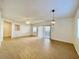 Open living room with tile flooring, ceiling fan, sliding glass doors to the patio, and neutral paint at 15225 N 100Th St # 1220, Scottsdale, AZ 85260