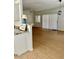 Living room view, showcasing tile flooring, neutral walls, fan, slider door, and a peek at the kitchen at 15225 N 100Th St # 1220, Scottsdale, AZ 85260