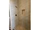 Shower features a showerhead, niche, neutral tile and light-colored flooring at 15225 N 100Th St # 1220, Scottsdale, AZ 85260