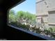 View from balcony shows lush landscaping with trees, plants, and gated access at 15225 N 100Th St # 1220, Scottsdale, AZ 85260