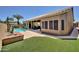 Beautiful backyard featuring a pool, patio with seating, artificial grass, and lush landscaping at 15273 S 31St St, Phoenix, AZ 85048