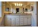 Bright bathroom boasts dual sinks, granite countertops, and stylish vanity lighting at 15273 S 31St St, Phoenix, AZ 85048
