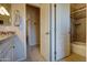 Well-lit bathroom featuring tiled shower/tub combo and open doorway at 15273 S 31St St, Phoenix, AZ 85048
