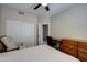 Cozy bedroom featuring a ceiling fan, closet, desk, and neutral tones at 15273 S 31St St, Phoenix, AZ 85048