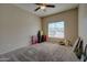 Carpeted bedroom with a ceiling fan, window and neutral walls at 15273 S 31St St, Phoenix, AZ 85048