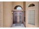 Up close view of the home's beautiful double door entry and its decorative wrought iron at 15273 S 31St St, Phoenix, AZ 85048