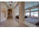 Open-concept hallway featuring pillars and tile flooring that leads to a living room with large windows at 15273 S 31St St, Phoenix, AZ 85048