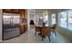 Bright kitchen with stainless steel appliances, granite countertops, and dining area with patio access at 15273 S 31St St, Phoenix, AZ 85048