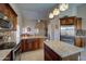 Gourmet kitchen featuring stainless steel appliances, granite counters, and an island with breakfast bar at 15273 S 31St St, Phoenix, AZ 85048