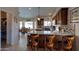 Gourmet kitchen with granite countertops, custom cabinets, stainless appliances, and breakfast bar seating at 15273 S 31St St, Phoenix, AZ 85048