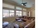 Relaxing living room featuring large windows offering views of the backyard pool area at 15273 S 31St St, Phoenix, AZ 85048