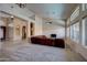 Bright living room with plush carpet, multiple windows, and stylish light fixtures at 15273 S 31St St, Phoenix, AZ 85048