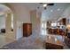 Spacious living area featuring high ceilings, arched doorway, and seamless flow to the kitchen at 15273 S 31St St, Phoenix, AZ 85048