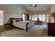 Spacious primary bedroom featuring carpet floors, high ceilings, and large windows at 15273 S 31St St, Phoenix, AZ 85048
