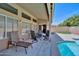 Covered patio with outdoor seating, a ceiling fan, and a view of the backyard and pool at 15273 S 31St St, Phoenix, AZ 85048