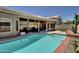 Backyard featuring a sparkling pool, a covered patio with seating, and mature landscaping at 15273 S 31St St, Phoenix, AZ 85048
