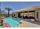 Backyard featuring a sparkling pool, covered patio with seating, and mature landscaping at 15273 S 31St St, Phoenix, AZ 85048