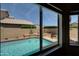 A scenic view of the sparkling pool and well-maintained backyard from inside the home at 15273 S 31St St, Phoenix, AZ 85048