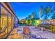 Tranquil backyard with brick-paved patio, outdoor seating, and manicured landscaping providing a relaxing ambiance at 16042 W Shaw Butte Dr, Surprise, AZ 85379