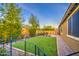 Expansive backyard with manicured artificial grass, a brick-paved patio, and well-maintained landscaping at 16042 W Shaw Butte Dr, Surprise, AZ 85379