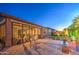 Backyard features a brick patio, a manicured lawn, and a covered patio perfect for outdoor entertaining at 16042 W Shaw Butte Dr, Surprise, AZ 85379