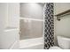 Bathroom featuring tiled shower and bathtub with black and white curtain at 16042 W Shaw Butte Dr, Surprise, AZ 85379