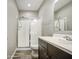 Bathroom with glass enclosed shower, white marble countertop and wood-style floors at 16042 W Shaw Butte Dr, Surprise, AZ 85379