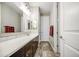 Bathroom features dual vanity sinks, white marble counters and dark cabinetry at 16042 W Shaw Butte Dr, Surprise, AZ 85379