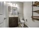 Bathroom features stylish wood floors, single vanity, custom shelving and lighting at 16042 W Shaw Butte Dr, Surprise, AZ 85379