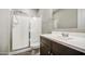 Bathroom with glass enclosed shower, white marble countertop and wood-style floors at 16042 W Shaw Butte Dr, Surprise, AZ 85379