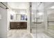 The bathroom showcases a double sink vanity, framed mirrors, and a glass-enclosed shower, offering modern amenities at 16042 W Shaw Butte Dr, Surprise, AZ 85379