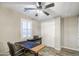 Cozy bedroom with ceiling fan, a wooden desk, a window and an ample closet at 16042 W Shaw Butte Dr, Surprise, AZ 85379