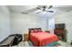 The bedroom features a ceiling fan, wood-look flooring, a queen bed, and a TV, offering a comfortable and stylish space at 16042 W Shaw Butte Dr, Surprise, AZ 85379