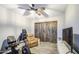 Features include an exercise bike, a wall mounted TV, wood look floors and sliding barn doors at 16042 W Shaw Butte Dr, Surprise, AZ 85379