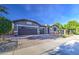 Beautiful single-Gathering home with three-car garage and landscaped front yard on a bright day at 16042 W Shaw Butte Dr, Surprise, AZ 85379
