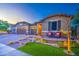 Inviting facade with a charming front porch, stone accents, and well-maintained landscaping at 16042 W Shaw Butte Dr, Surprise, AZ 85379