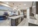 Spacious kitchen featuring an island, stainless steel appliances, and dark wood cabinetry at 16042 W Shaw Butte Dr, Surprise, AZ 85379