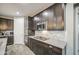 Close-up of modern kitchen with granite countertops, stainless steel appliances, and marble backsplash at 16042 W Shaw Butte Dr, Surprise, AZ 85379