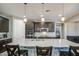 Gourmet kitchen with a large island, modern lighting, and stainless-steel appliances at 16042 W Shaw Butte Dr, Surprise, AZ 85379