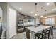 Open-concept kitchen with large island, stainless steel appliances, and dark wood cabinets at 16042 W Shaw Butte Dr, Surprise, AZ 85379