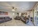 Spacious living room boasts leather furniture, an open layout and sliding doors to the outdoor patio at 16042 W Shaw Butte Dr, Surprise, AZ 85379