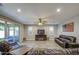 The living room features comfortable leather seating, a fireplace with TV and outdoor patio access at 16042 W Shaw Butte Dr, Surprise, AZ 85379