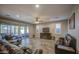 Relaxing living room boasts comfortable leather seating, access to patio and fireplace with TV at 16042 W Shaw Butte Dr, Surprise, AZ 85379