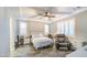 The spacious main bedroom boasts a ceiling fan, recessed lighting, a king bed, and shuttered windows for natural light at 16042 W Shaw Butte Dr, Surprise, AZ 85379