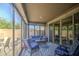 Covered patio featuring comfortable blue cushioned seating and sliding glass doors perfect for indoor-outdoor living at 16042 W Shaw Butte Dr, Surprise, AZ 85379