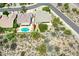 An aerial view shows a backyard pool with a patio set and beautiful desert landscaping at 16861 N 106Th Way, Scottsdale, AZ 85255
